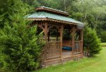You can relax in the shared gazebo right on the creek